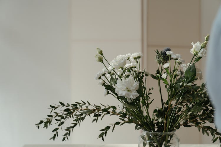 A Floral Arrangement In A Glass Vase