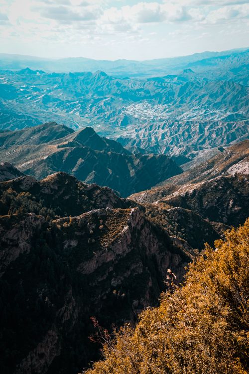 Free Stunning aerial photograph showcasing a vast mountain range under a clear sky. Stock Photo