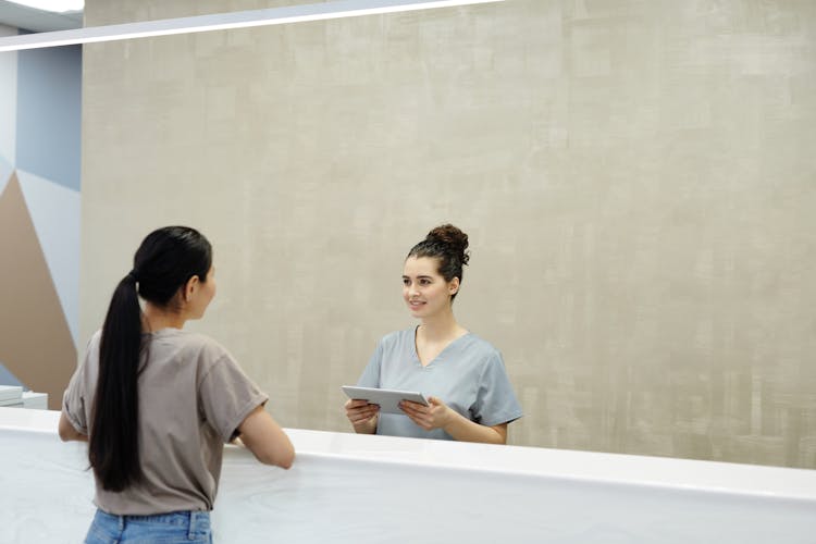 A Receptionist Smiling At A Person