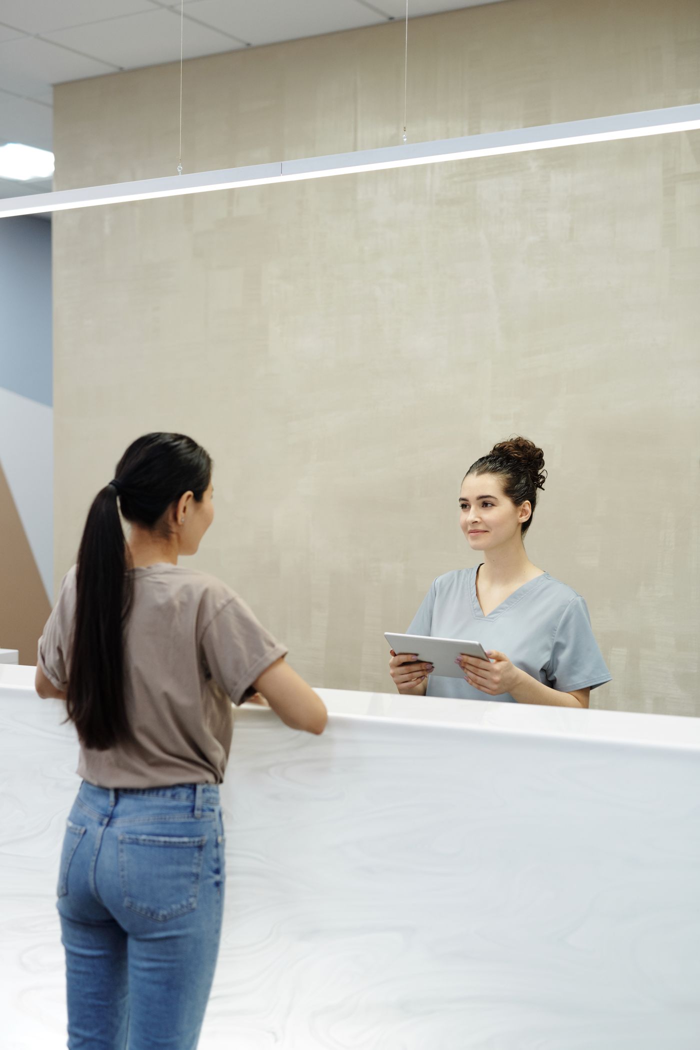Healthcare professional speaking with a patient in a clinical setting