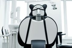 Bright dental clinic room with a modern dental chair and equipment. Ideal for healthcare imagery.