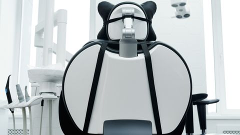 Bright dental clinic room with a modern dental chair and equipment. Ideal for healthcare imagery.