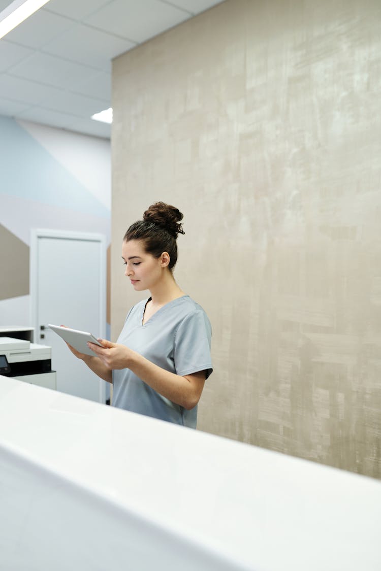 A Receptionist Looking At A Tablet