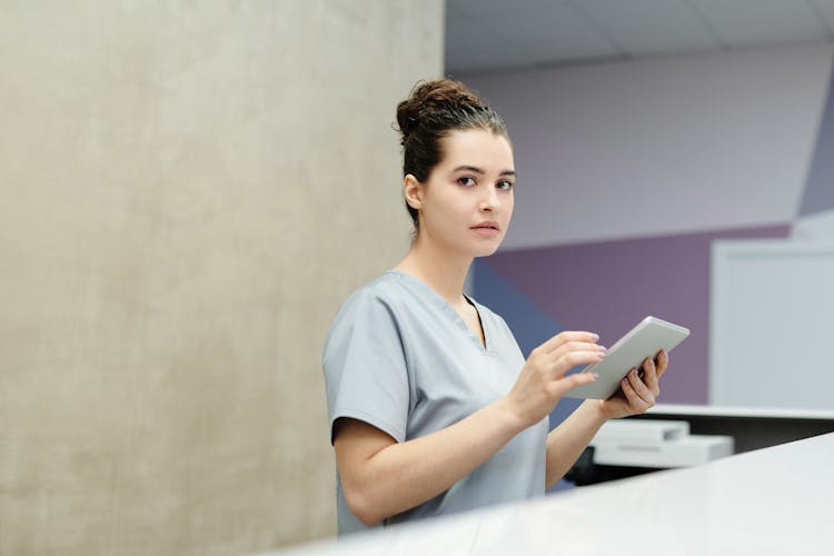 A Receptionist Holding A Tablet