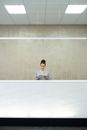 Woman Employee Standing behind Front Desk