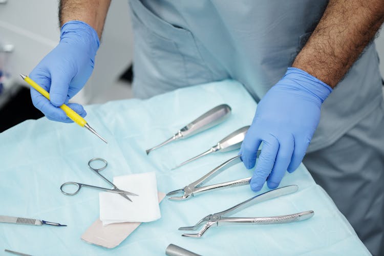 Person Holding Dental Tools