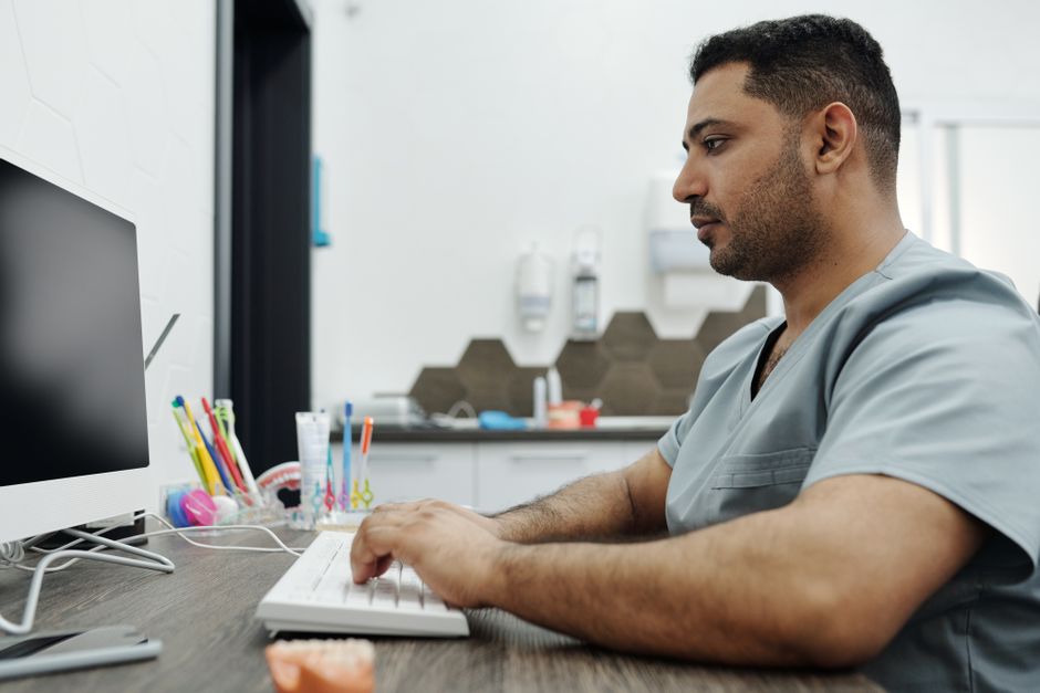 Dentist reviewing VAT figures on a tablet in a UK dental practice
