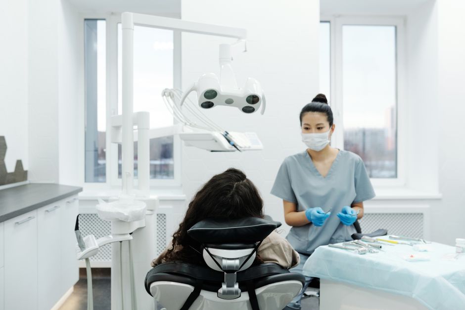 Dental practice owner reviewing equipment purchase invoices with accountant for annual investment allowance claim
