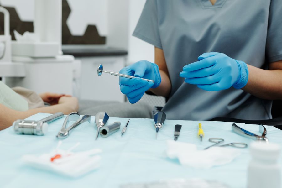 Dental professional with clinical instruments