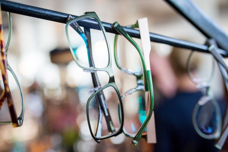 Eyeglasses Hanging On A Metal Rod