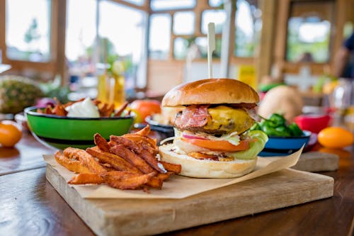 Burger and Fries on a Wooden Board 