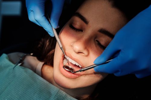 Free Close-up of a dental examination showing a woman patient receiving dental care from a professional. Stock Photo