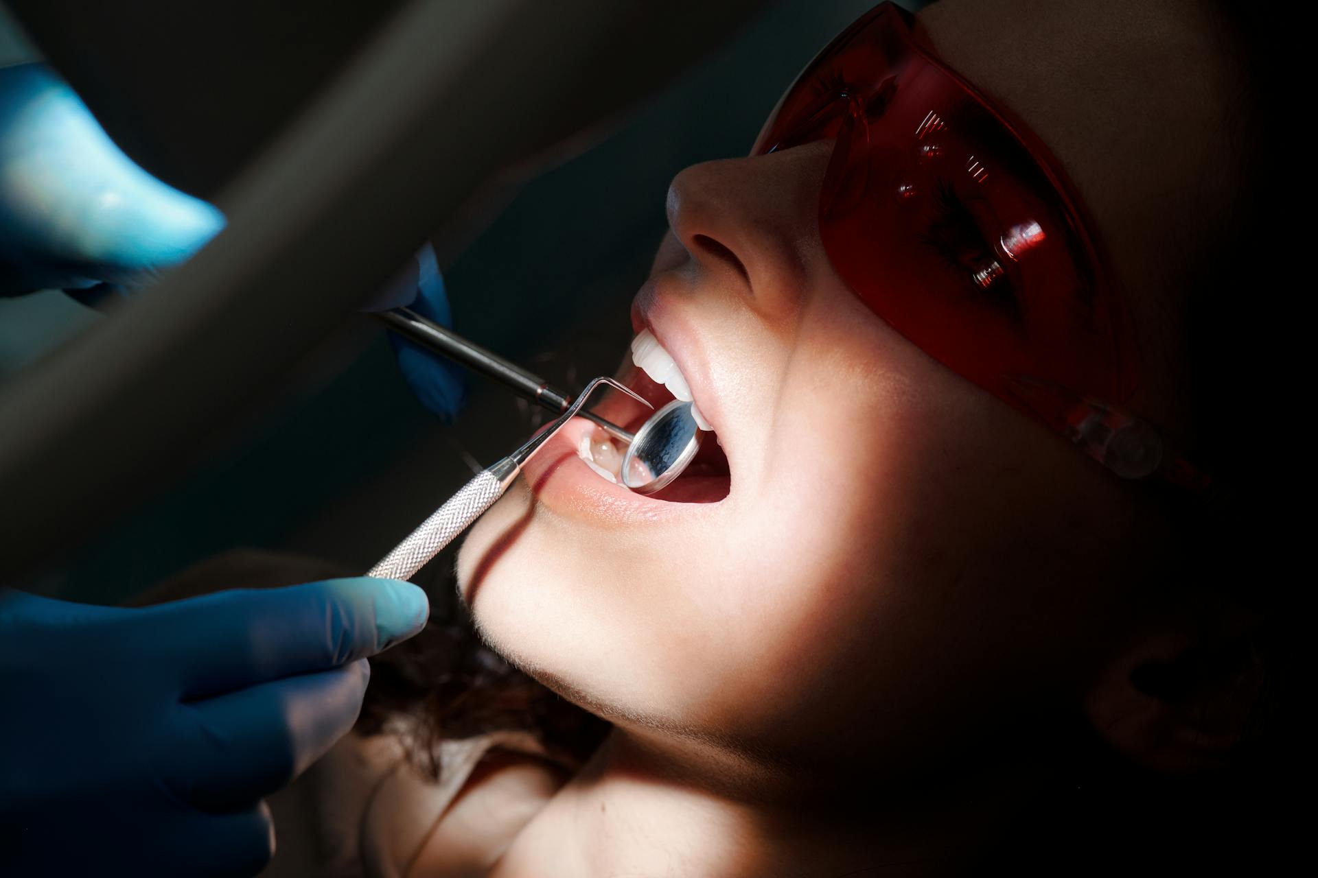 A Dentist Checking a Woman's Mouth