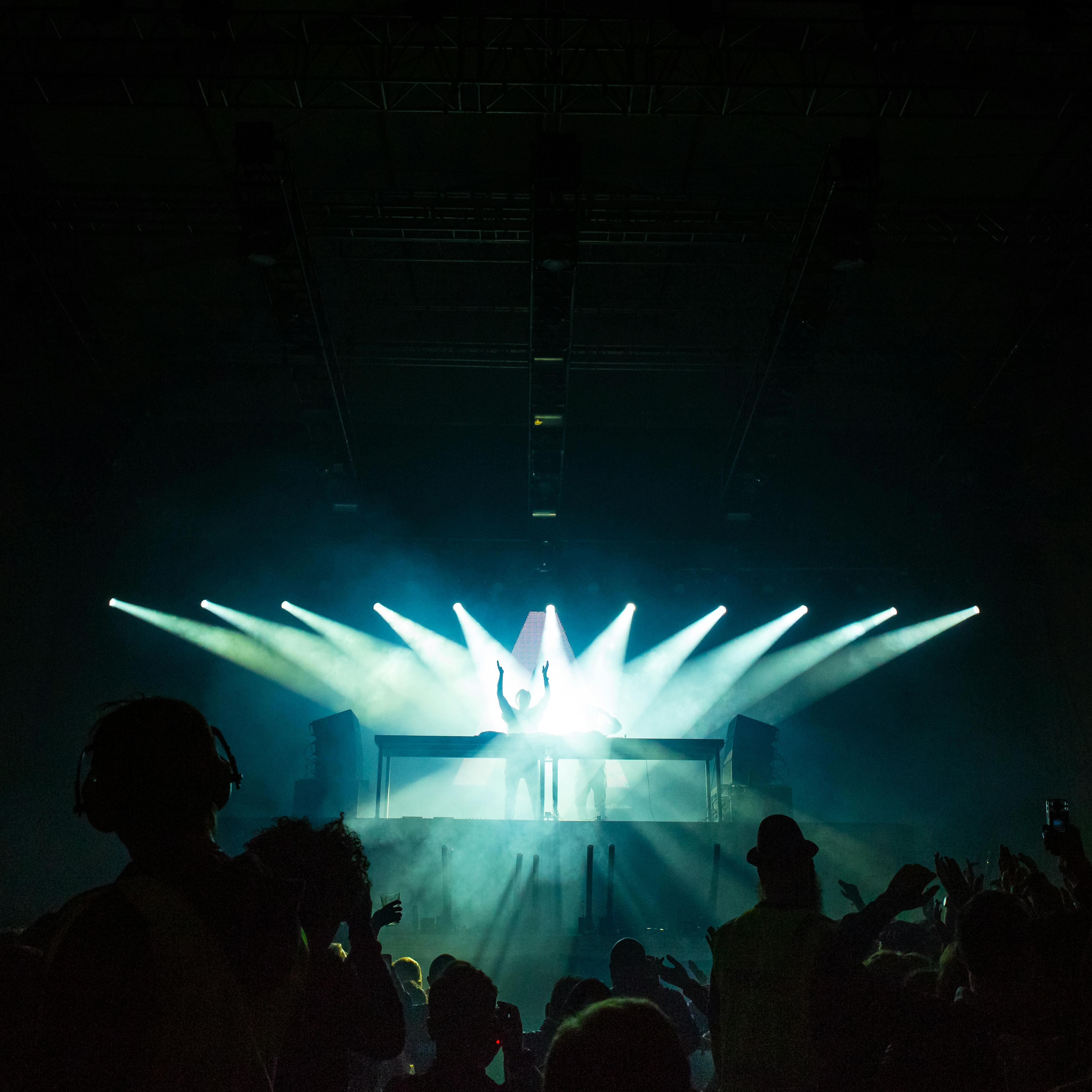 People Inside Dark Room With Spotlights