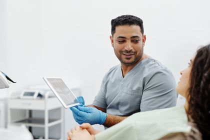 Nurse using a digital tablet during a patient consultation — Cedric Fauntleroy on Pexels