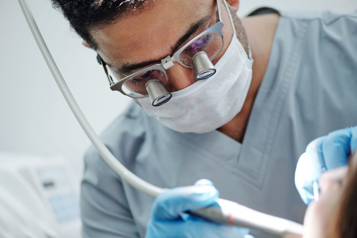 Dentist performing painless root canal treatment in Whitefield