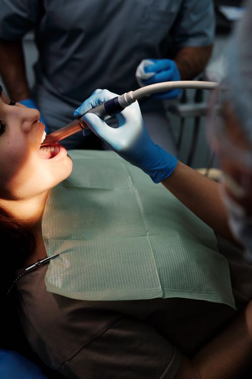 Free Close-up of dental procedure with equipment and patient in modern clinic setting. Stock Photo