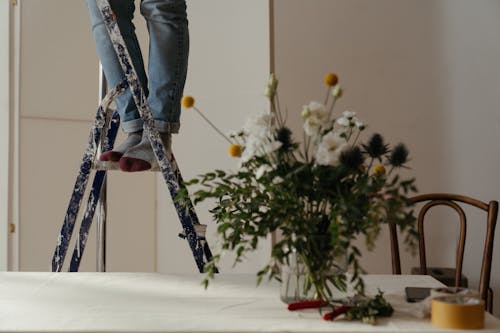 Person in Blue Denim Jeans and Black Leather Boots Playing Ice Hockey