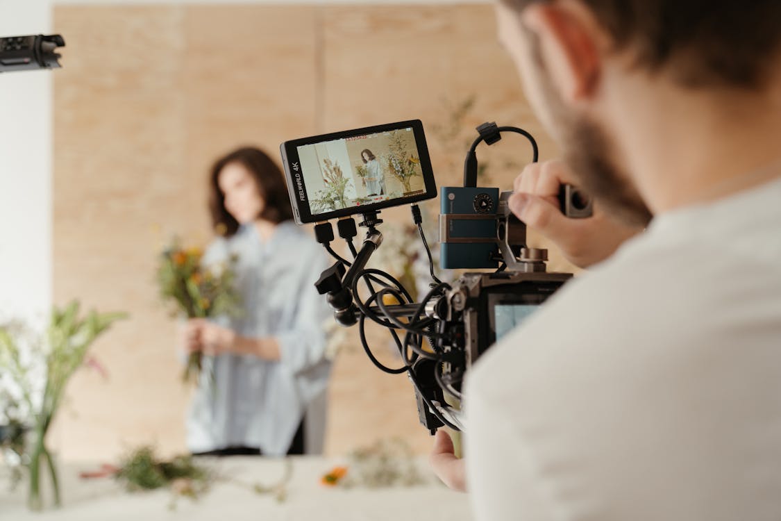 Camera man capturing video and photos of a celebrity.