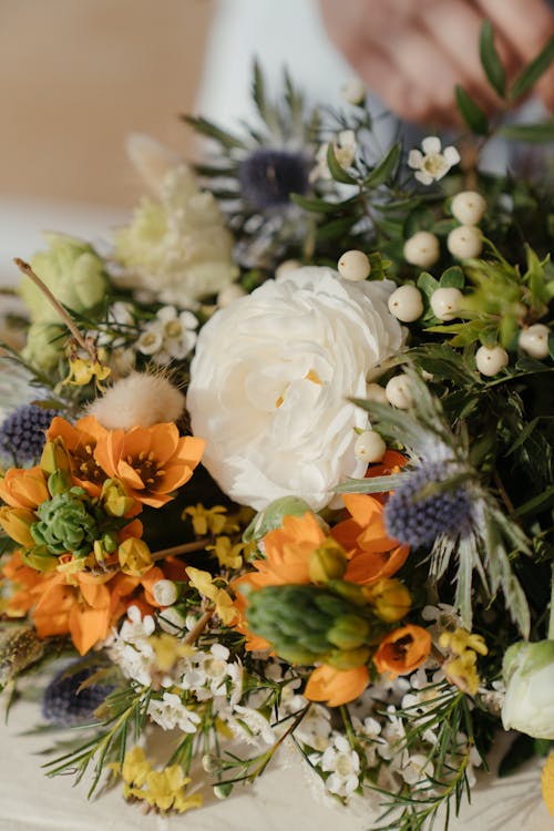 White and Orange Flowers on Blue and White Textile