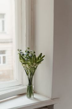 窗前玻璃花瓶里插着美丽的花束