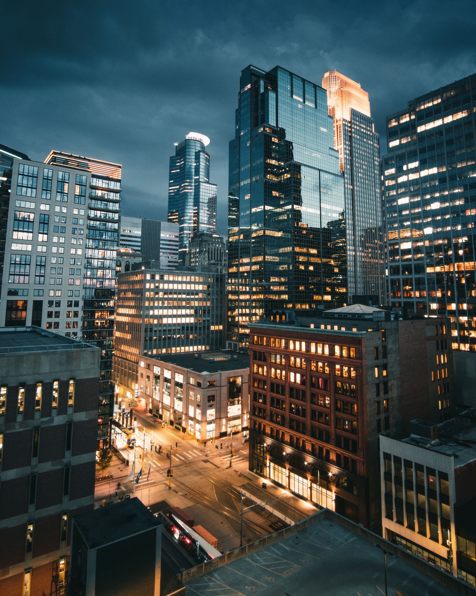 Downtown Minneapolis skyline at night with illuminated skyscrapers.