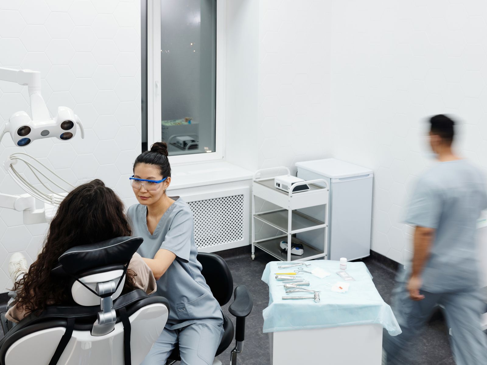 Smiling dental patient and clinician in a bright modern private dental clinic