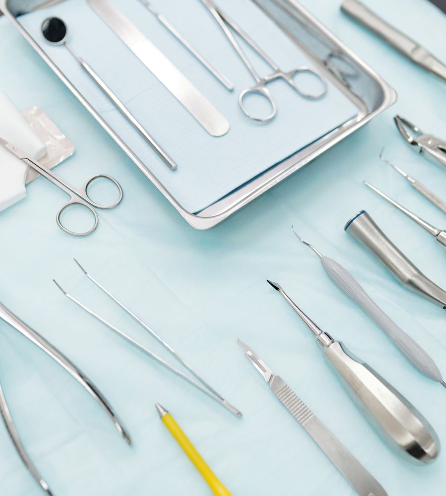 Stainless steel dental instruments arranged on blue cloth