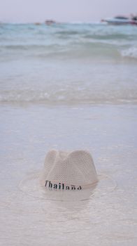 A beach hat floats in gentle waves near the shore in Thailand, capturing a serene coastal vibe.