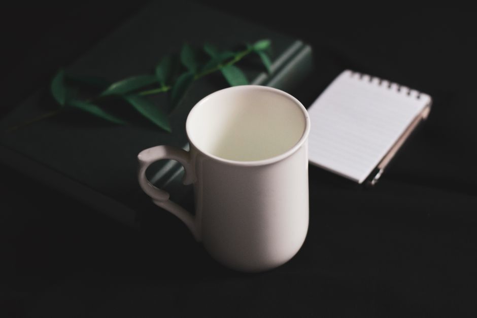 coffee mug beside planner everyday scene lifestyle photo 1
