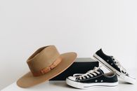 Brown Fedora Hat Beside Black and White Low Top Sneakers