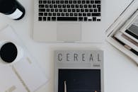 A Flatlay of Magazines and a Laptop