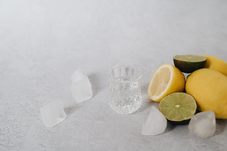 Glass, Lemons, Limes And Ice Cubes