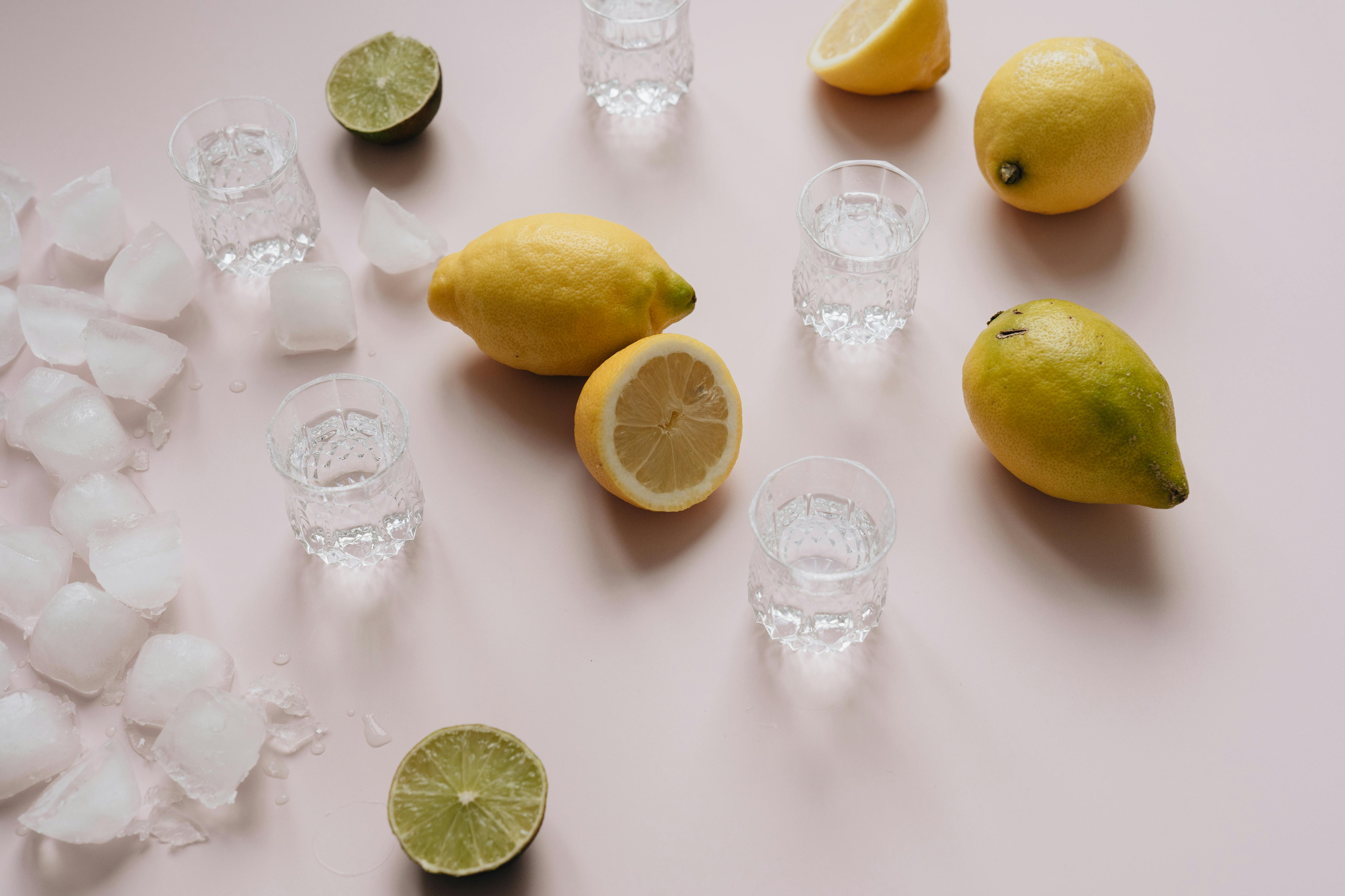 glasses lemons limes and ice cubes