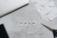 Paper Cut Out of Letters Forming the Word Open