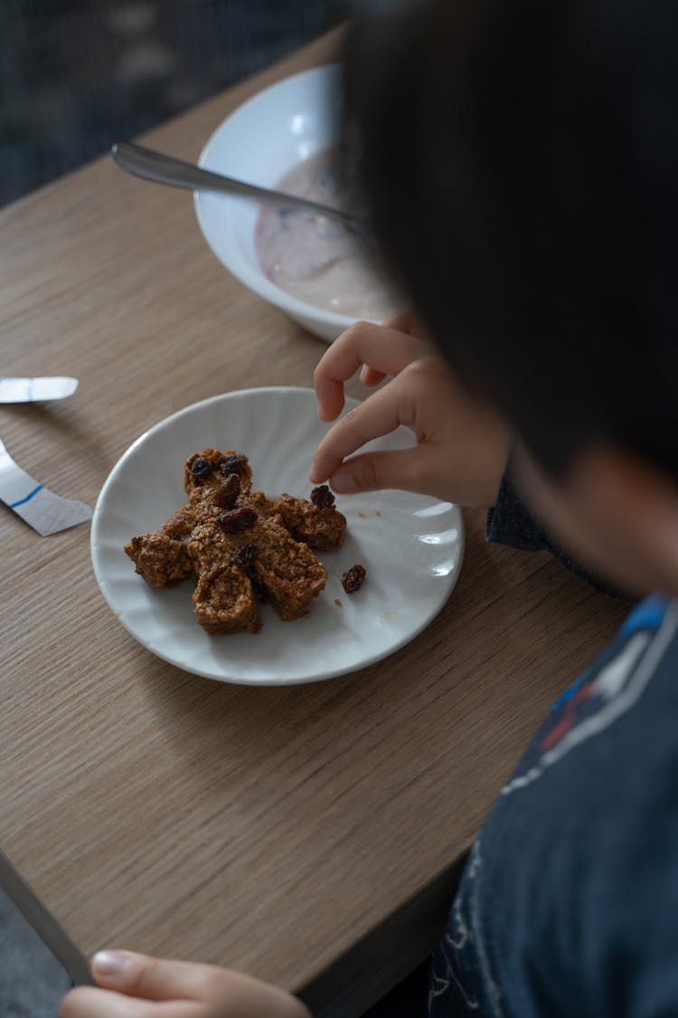 Crop Faceless Person Eating Dessert With Hands