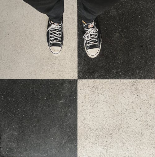 Photo of Shoes on Black and White Tiles