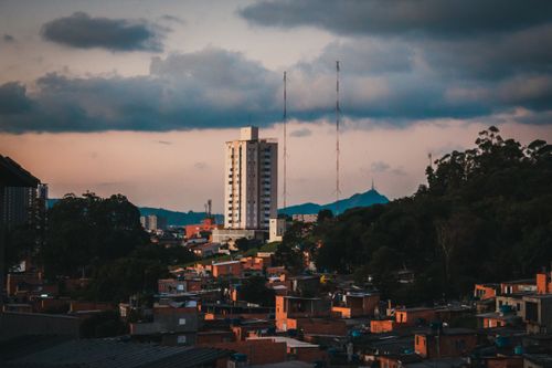 Free Scenery of old small city district located on highlands against picturesque cloudy sky in evening Stock Photo