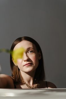 这幅女性肖像经过深思熟虑，前景模糊，突出了宁静而温柔的光线
