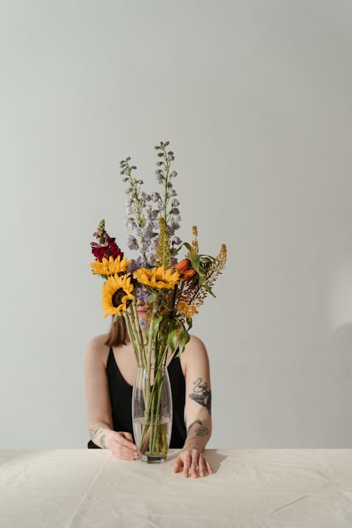 Woman Holding Yellow and White Flower Bouquet