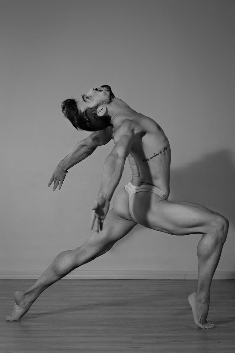 Graceful Male Dancer Practicing In Light Studio