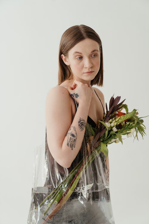 Woman in White Tank Top Holding Green Plant