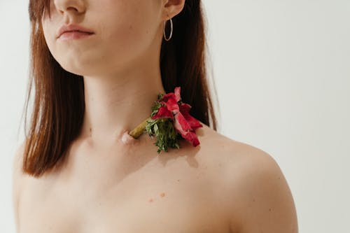 Woman With Red Rose on Her Ear