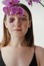 Woman With Purple Flower on Her Ear