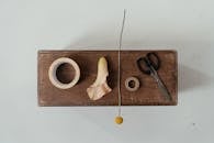 Black Scissors on Brown Wooden Chopping Board