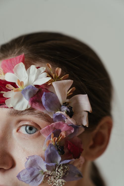 Woman With White and Purple Flower on Her Head