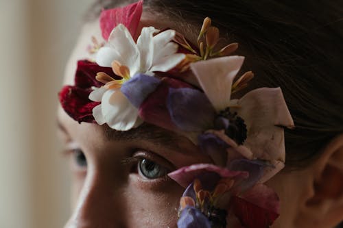 Woman With White and Purple Flower on Her Ear