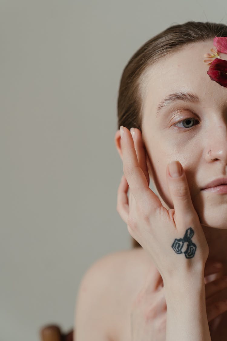 Woman With Black And Red Floral Tattoo On Her Left Hand