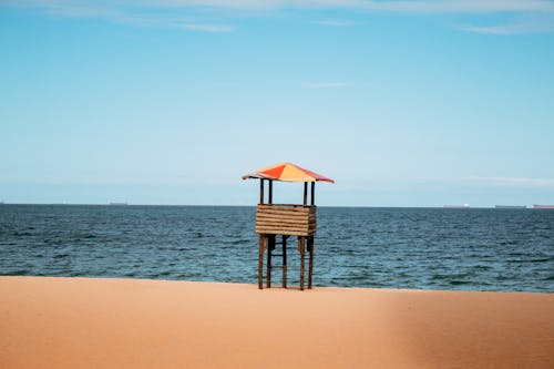 Free Brown Wooden Lifeguard Tower on Beach Stock Photo