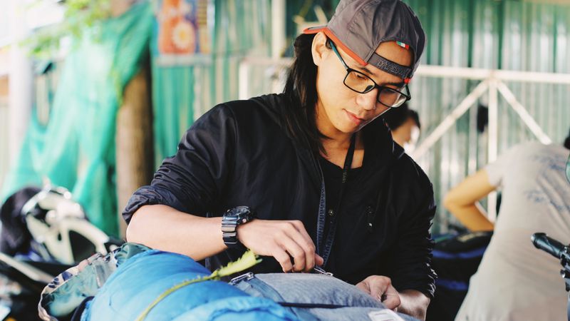 Young traveller preparing a backpack before setting off.